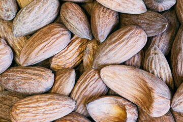 Fototapeta premium Almond nuts close. Background of almond nuts. Pile of almonds cl