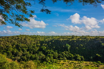 Green mountains and valleys of the island of Haiti. Blue mountains, green valley. Panoramic view of Haiti mountains in summer day. Tourism and travel concept. Natural green forest background panorama.