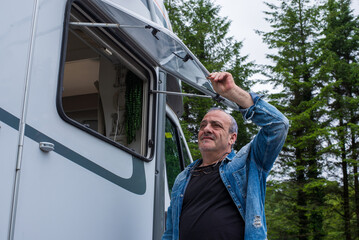 man closing motorhome window,