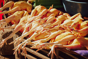 Fresh raw chicken on display in a traditional market