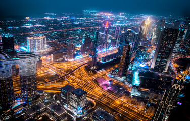 Plakat Dubai, UAE. Dubai city at night, view with lit up skyscrapers and roads.
