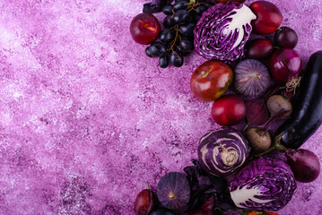 Assortment of purple vegetables on violet background