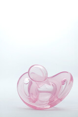Close-up of Pink Baby Pacifier on White Bacground