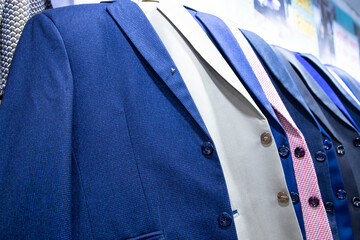 Men's clothing on hangers in a shop, closeup of photo