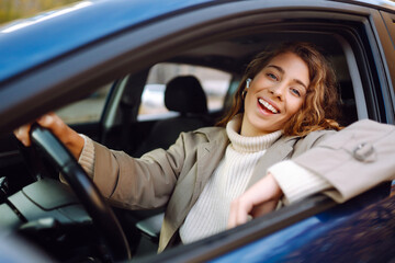 Young woman drive a car. Automobile journey, traveling, lifestyle concept. Car sharing.