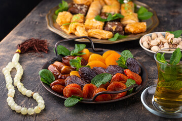 Fototapeta na wymiar Ramadan iftar traditional desserts baklava and dates