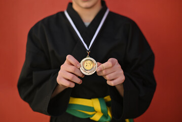 Winner hand raised and holding award medal.Concept of sport, education, skills, workout, health. 