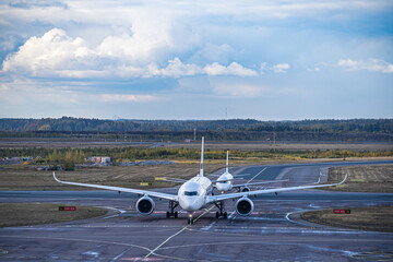 Helsinki, Finland airport plane spotting: Two Finnair airplanes taxiing together: an Airbus...
