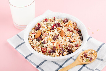 Oat muesli with nuts, dried berries and seeds in a bowl for a healthy breakfast