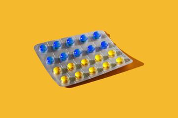 blister pack with pills on a yellow background