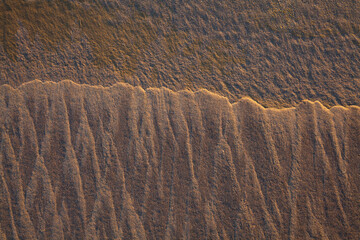 Fototapeta premium Closeup abstract of patterns and textures in sand 