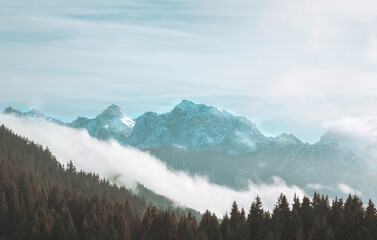 Panorama view of the snowy mountains between Austria, Slovenia and Italy. Peaks of Slovenian Alps, cloudy weather.