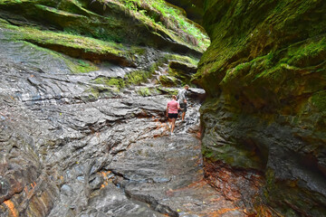 A couple hikes a deep ravine trail in Turkey Run State Park, Indiana.