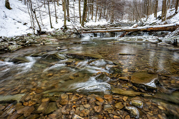 Mountain stream in winter scenery. Prowcza Stream, Bieszczady National Park, Carpathian Mountains, Poland. One of the most popular travel destinations in Poland.