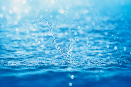 water falling splash with blue bokeh background