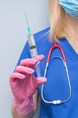 doctor holding a syringe with medicine in his hand.