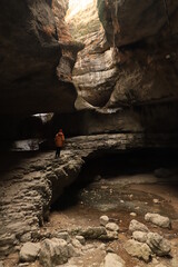 Bizarre shapes in a dark mountain gorge - with layers illuminated by the sun.