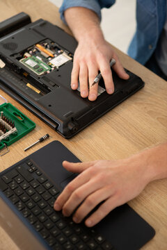 cropped image of a laptop being repaired
