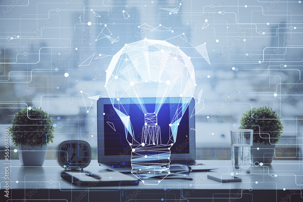 Poster computer on desktop in office with bulb icon hologram. double exposure. concept of idea.