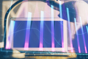 Stock market graph on background with desk and personal computer. Multi exposure. Concept of financial analysis.