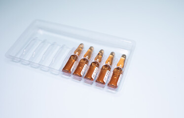 Ampoules with medicine on a blue background. Vaccination, injections, medicine. The concept of medicine and immunity. Vaccination against viral infections. Injections, antibiotic.
