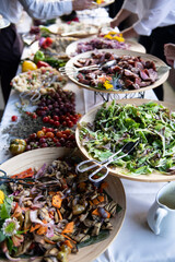 A closeup shot of a wedding buffet with healthy dishes in circular plates