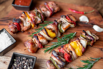 Meat kebabs with grilled vegetables on a rustic background