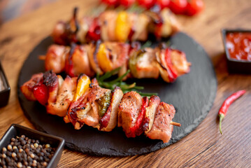 Meat kebabs with grilled vegetables on a rustic background