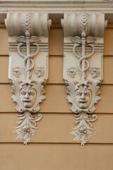 Sculptural decoration with human faces on building wall in Odessa, Ukraine