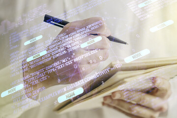 Double exposure of abstract programming language with world map and man hand writing in notebook on background, research and development concept
