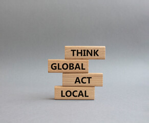Think global act local symbol. Wooden blocks with words Think global act local. Beautiful grey background. Business and Think global act local concept. Copy space.