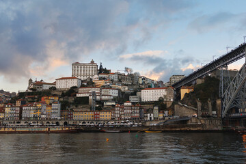 Fototapeta na wymiar Historic centre, Porto, Portugal - center of town and city. Douro river, embankment and waterfront, building and houses and histrocial landmarks and monuments. Evening before dusk, cloudy sky.