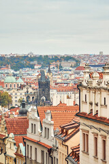 Fototapeta premium Facades of old buildings with tile roofs in downtown of Prague. Cityscape on the horizon.