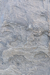 Close-up of a strange and beautiful rock surface, front view. Abstract full frame natural textured background.