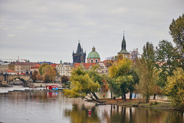 Fototapeta premium View of Bedrich Smetana Museum and trees next to the Vltava in Prague, Czech.