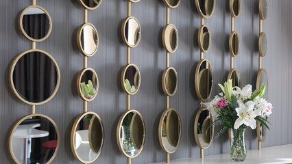 many round decorative mirrors hanging on the wall