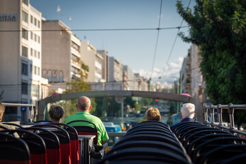 View from open roof of red, turistic hop on bus with tourists inside. Vacation, travel concept