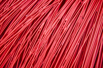 Bright red plastic wire as a background. Beautiful textured surface.