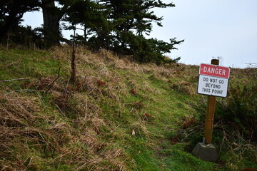 danger sign on coastal cliff