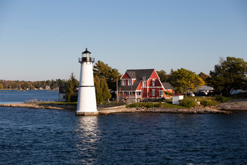 Fototapeta na wymiar Lighthouse, red house, lake, thousand Island, white lighthouse 