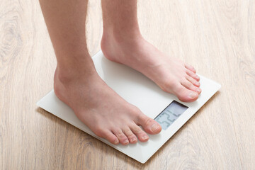 A man stands on the scales.Diet, weight loss concept.