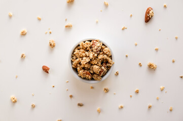 Bowl of Granola on a White Table Background. Healthy foods.