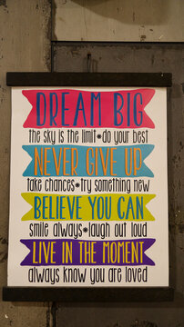Hanging motivational word about life sign at the wall that say dream big, do your best, never give up, take chance, try something new, belive you can, smile always, live the moment.