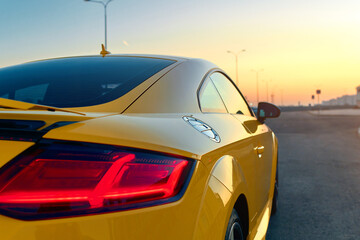 yellow sports car at sunset