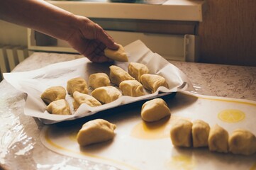Women's hands making sweet dough buns
