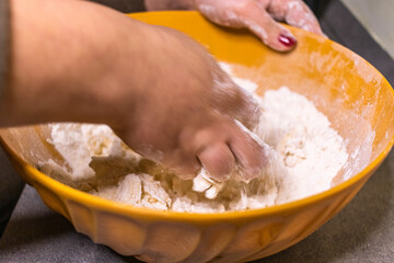 Close-up of a chef's hands making crostata Italian cheese and chocolate cake. Cook mixing dough