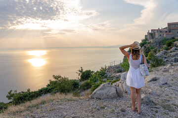 The famous Lubenice village at sunset over the sea in Cres island Croatia with a woman tourist