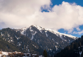 Snowy mountains and sky on a sunny winter day. A view from Rize Ayder plateau.Camlihemsin, Rize, Turkey. 