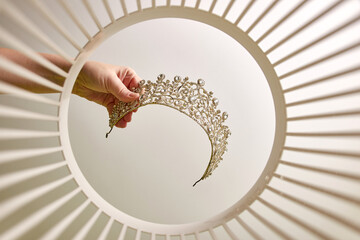 The jeweled crown is thrown into the trash. View from below. The concept of recycling and waste...