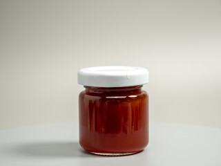 A jar of apple jam. Homemade apple jam on a gray background.